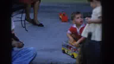 Glendale California (1962): There Are Two Kids Playing With Toys Over A Carpet
