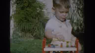 Glendale California (1962): Toddler Wearing White Shirt Bangs Wooden Toy Gavel On