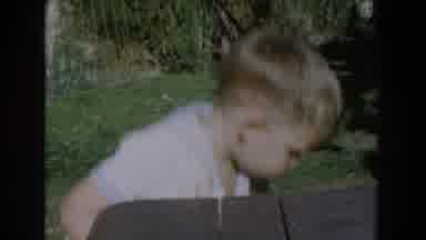 Glendale California (1962): Innocent Kid Picking Up Toys On The Yard Looking For