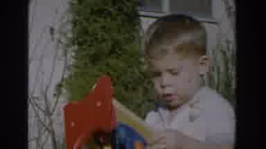 Glendale California (1962): Child Hitting His Toy Hammer On Another Toy While