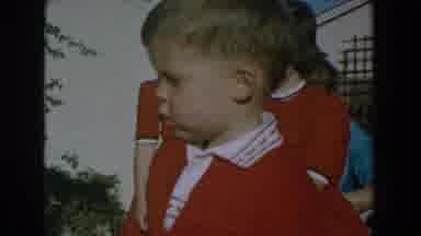 GLENDALE CALIFORNIA-1962: A Young Boy in Red Sweater Outside with Other Children