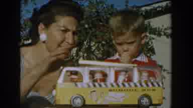Glendale California (1962): A Lady Playing With His Kid Who Has His Finger In His