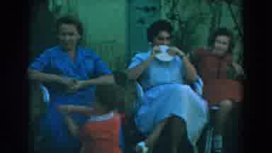 Glendale California (1962): Three Women Sitting In Tan Chairs Talk To Man Wearing