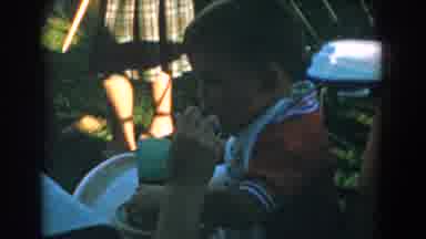 Glendale California (1962): Lady Spoon Feeding Young Child Wearing Bib Outside On