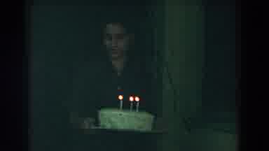 Glendale California (1962): A Guy Is Holding A Cake With Three Lit Candles To