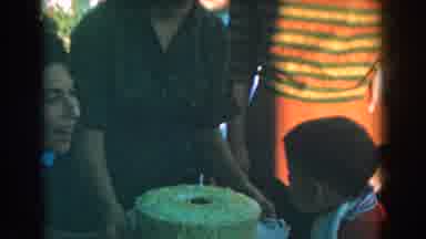 Glendale California (1962): A Boy Blowing Off The Lights From A Candle On His