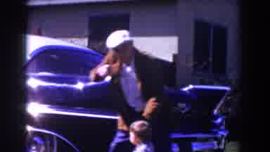 Glendale California (1962): Man Wearing White Hat Stands In Front Of Parked Black