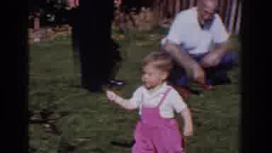 Glendale California (1962): Young Boy Chi In Pink Overalls Walking Pulling A Toy