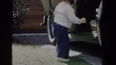 Glendale California (1962): Toddler Wearing Black Hat Climbs Into Black Car On A