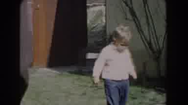 Glendale California (1962): Toddler Wearing White Sweater Walks On Green Grass On