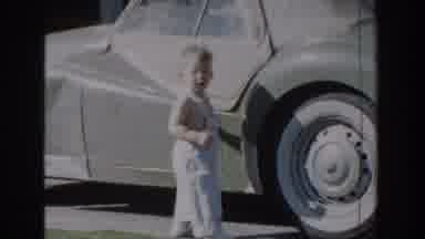 Glendale California (1962): A Kid Is Opening The Door Of A Car And Trying To Get