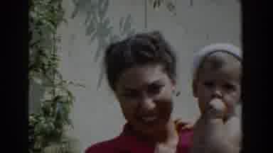 Glendale California (1962): Smiling Woman With Baby In Red Dress At Home Yard