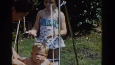Glendale California (1962): Young Girl Swings Her Baby Brother