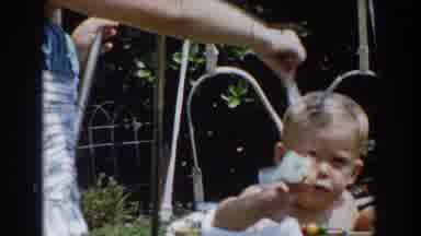 Glendale California (1962): Mother Plays With Her Son Who Stands Inside His