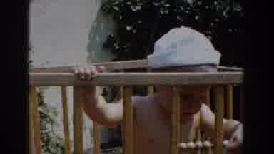 Glendale California (1962): Baby Human In A Wooden Crib Wearing A White Hat