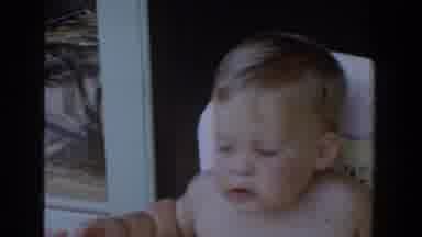 Glendale California (1962): Unclothed Fair Haired Toddler Being Spoon Fed In Their