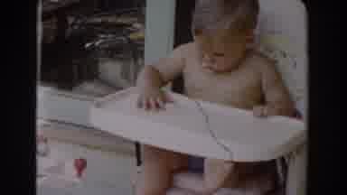 Glendale California (1962): A Baby Picked Food Crumbs From A Plastic Table And