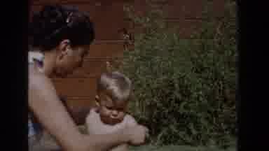Glendale California (1962): Young Boy Plays With His Mother And Sits In A High