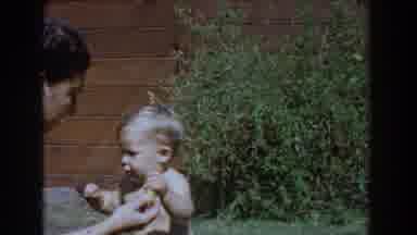 Glendale California (1962): Mother Playing With Her Son Crawling In Her Backyard