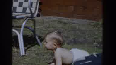 Glendale California (1962): Baby Wearing White Bloomers Grabs Object From Orange