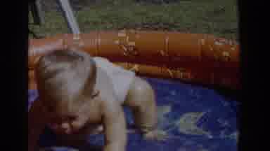 Glendale California (1962): A Baby Trying To Get Out Of The Bath As He Is Being