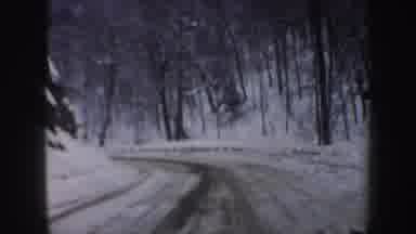 New Hampshire (1962): A Vehicle Drives Down A Snow-Covered Road In A Forest With