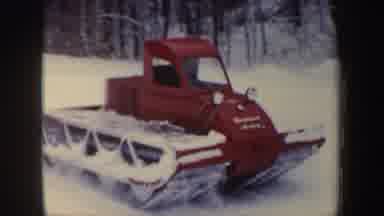 New Hampshire (1962): A Large Red Snowmobile Drives Across Snow In Front Of Trees