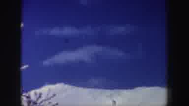 New Hampshire (1962): Three Adults Are Skiing In The Snowy Mountain In The Daytime