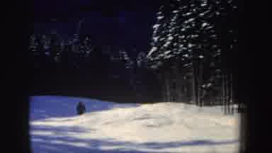 New Hampshire (1962): Two People Skiing Downhill Past Snow Covered Trees On A