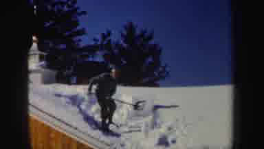 New Hampshire (1962): A Guy With A Shovel Over The Roof Of A House Covered With