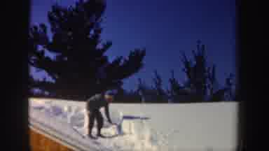 New Hampshire (1962): Person Standing On Roof With Shovel Chopping Off Blocks Of