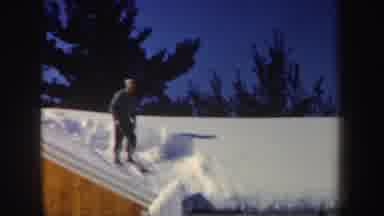 New Hampshire (1962): Man Stand On Roof As Snow Falls Off And Ground Is Covered In