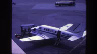 Copenhagen Denmark (1975): A Pilot Alight From An Aircraft As A Moving Bus Is Seen