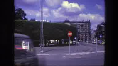 Copenhagen Denmark (1975): Passing View Of Gray Buildings And Light Traffic On A