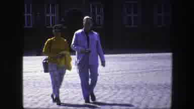 Copenhagen Denmark (1975): Pairs Of People Walking Across A Stone Courtyard In