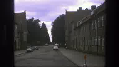 Copenhagen Denmark (1975): Cars Packed By The Street Between Two Large Buildings