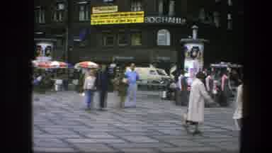 COPENHAGEN DENMARK-1975: Crowds Walk Around A Downtown Square And Nearby Busy