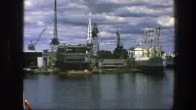 Copenhagen Denmark (1975): A Port With Dark Water And Many Buildings And Factories