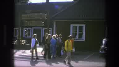 Copenhagen Denmark (1975): Small Group Of People Walking Past Dark Green Building