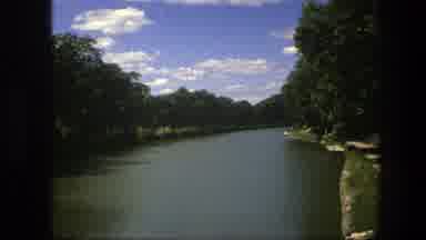 Copenhagen Denmark (1975): Trees On Either Bank Of A River During The Day With