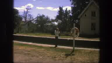 Copenhagen Denmark (1975): Person Wearing White Sweater Walks Past Flying Denmark