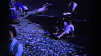 Ireland (1961): A Group Of People Pitted Down On Rocks And A Little Girl Patted