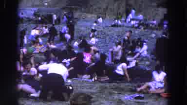 Ireland (1961): Large Crowd Rests On Green Grass On A Sunny Day