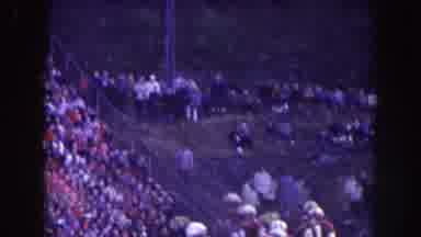 Nebraska (1957): Spectators Sit On A Hill And In Bleachers And Watch A Football