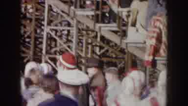 Nebraska (1957): Young Male Football Players Running Onto The Field As Fans Sit In