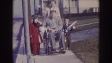 Nebraska (1957): Woman Taking Her Husband For A Wheelchair Ride With Her Children