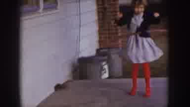 Nebraska (1957): A Young Girl In A Dress And Bright Red Stockings Hula Hooping