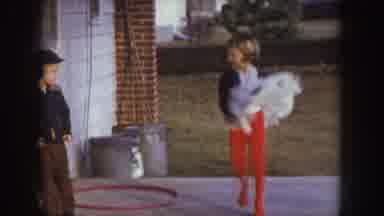 Nebraska (1957): One Boy And One Girl Standing Outside House Girl Is Dancing