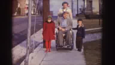 Nebraska (1957): A Guy On A Wheelchair Being Pushed By His Wife And Their Kids