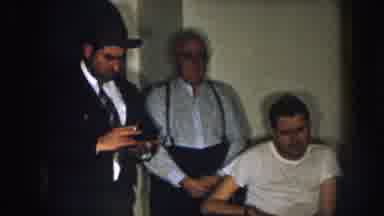 Nebraska (1957): Disabled Man Surrounded By Possibly Amish Family In A Dark Room